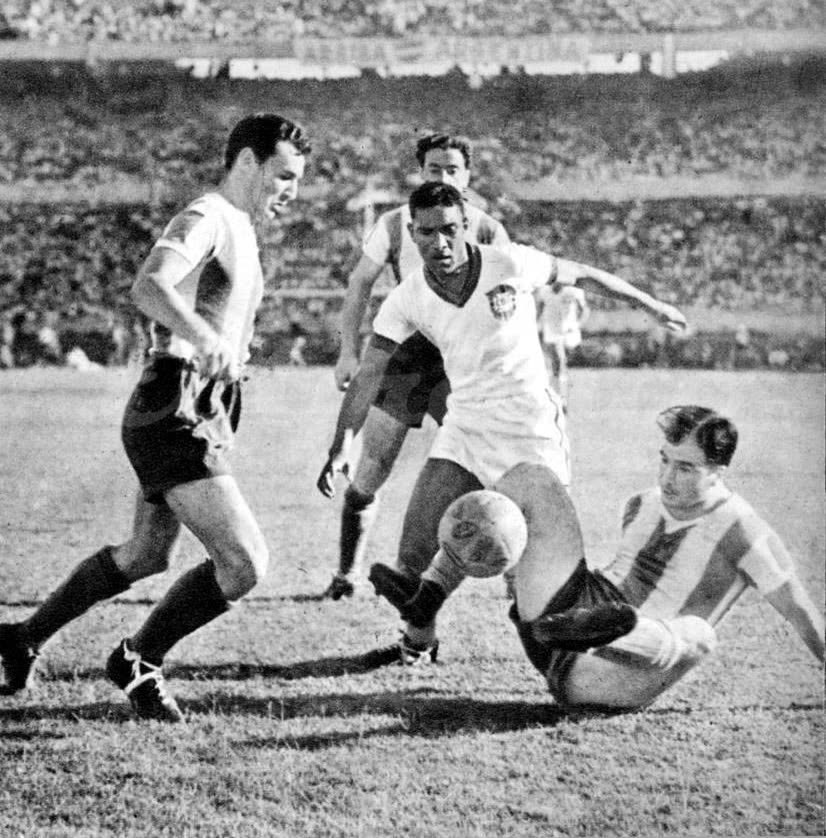 Black and white photo of Argentina and Brazil players challenging for the ball.