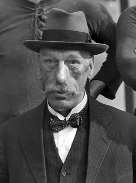Portrait of Sir Henry Norris in a hat and bow tie.