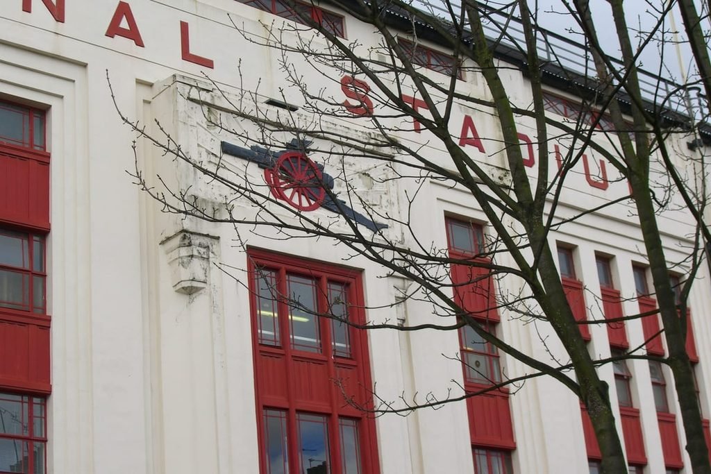 The white Art Deco front of Highbury's East Stand with the Arsenal cannon above the door.