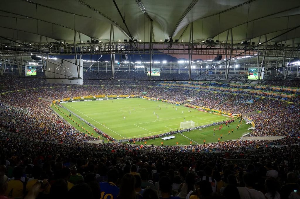 The Maracanã stadium in Rio de Janeiro, full and floodlit.