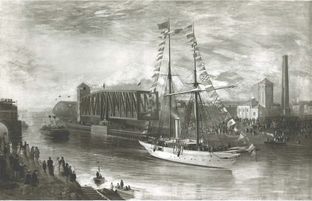 Old photo of a sailing yacht decorated with flags opening the Manchester Ship Canal in 1894.